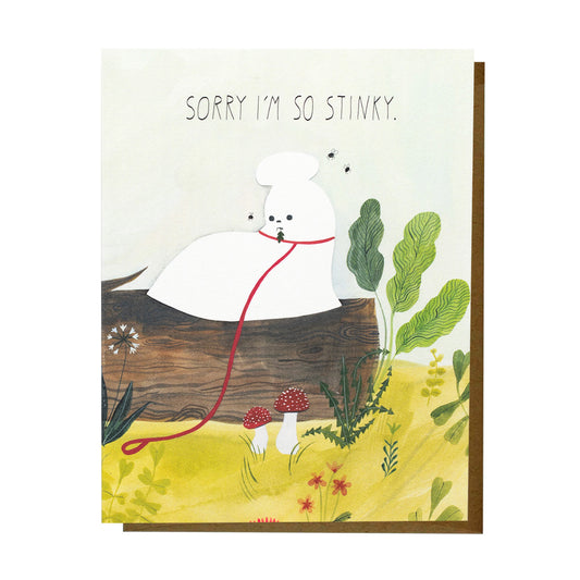 Illustrated card reading ‘Sorry I’m so stinky.’ featuring a white dog sitting on a log with flies buzzing nearby, surrounded by plants and mushrooms.
